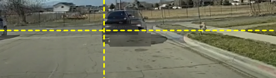 The two moments blended half and half: a single crisp car sits on the crosshair.