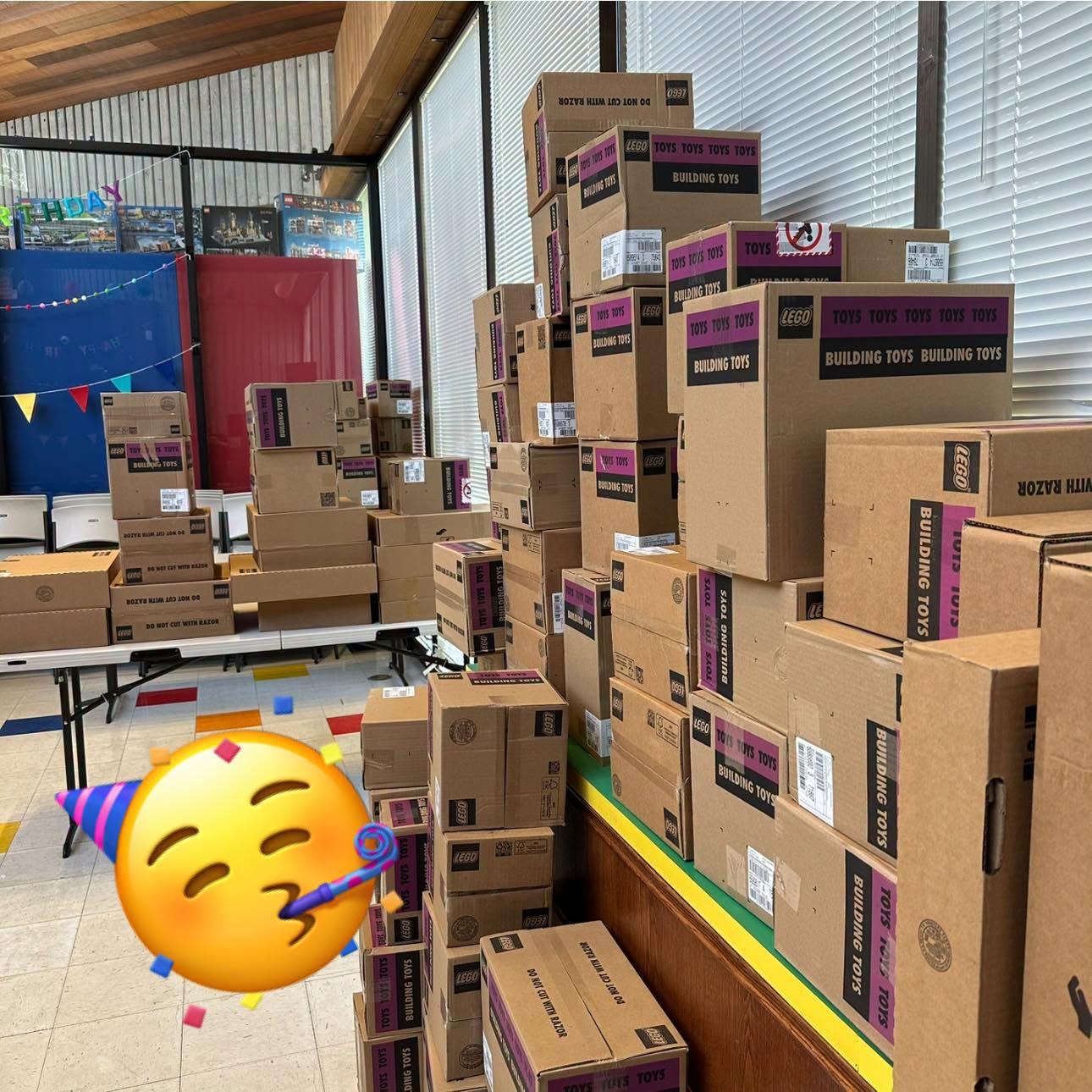 A wall of sealed LEGO master cartons stacked inside the Boise store, from the Total AFOL post about the August shipment.